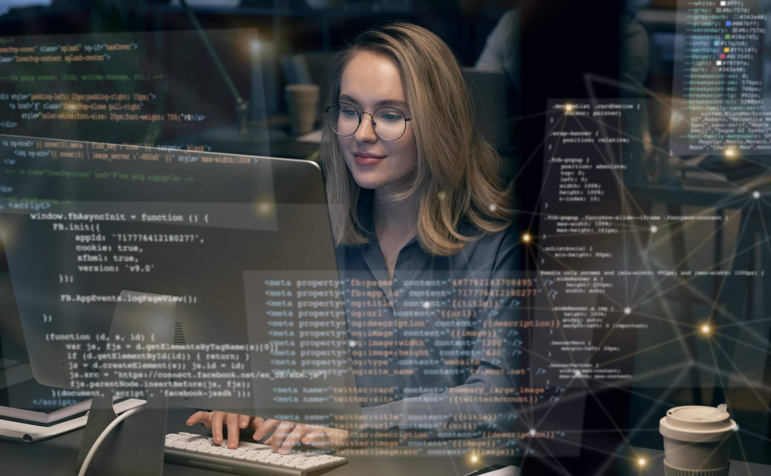 A person working on a computer with HTML and CSS code on the screen